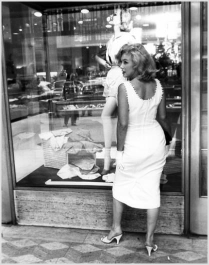 Marilyn Monroe on Fifth Avenue, NYC Photo by Sam: Description of image: Marilyn Monroe stopping to look into a store window on Fifth Avenue in New York City, 1956. Sam Shaw caught many angles of Marilyn and she was stunning in all of them. This image