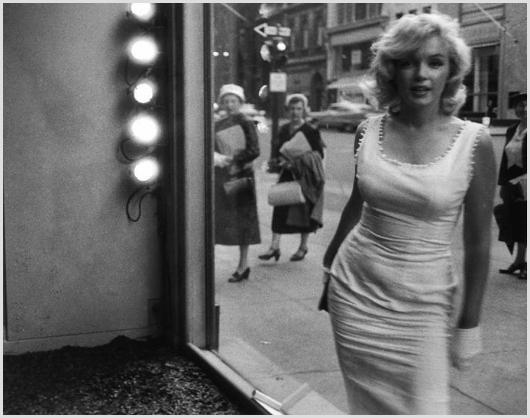 Marilyn Monroe Looking into Window, NYC Sam Shaw: Description of image: Marilyn Monroe stopping to look into a store window on Madison Avenue in New York City, 1956. Sam Shaw photographed Marilyn while he was actually standing in the store window, as