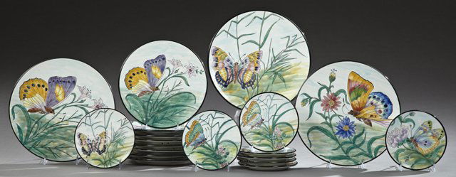 Nineteen Piece Spanish Earthenware Partial Dinner: Nineteen Piece Spanish Earthenware Partial Dinner Service, 20th c., consisting of eight dinner plates, three circular platters, and eight salad plates, each with bright floral and butterfly decoration