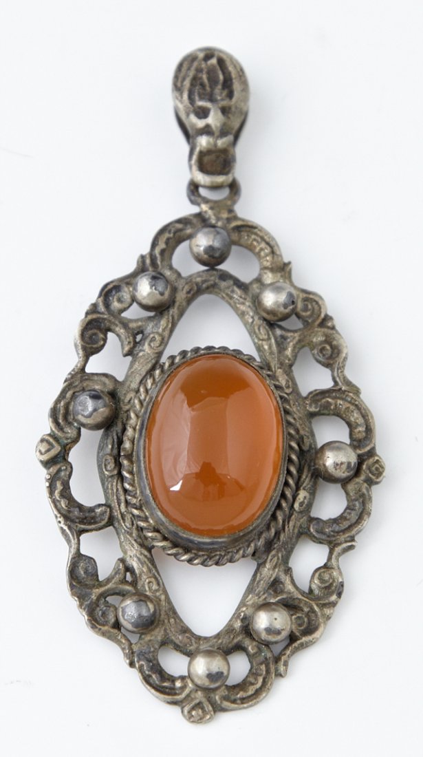 Peruzzi Sterling Carnelian Pendant, mid 20th c., the: Peruzzi Sterling Carnelian Pendant, mid 20th c., the oval cabochon carnelian centering a pierced relief frame, H.- 2 3/8 in., W.- 1 1/4 in., D.- 1/2 in.