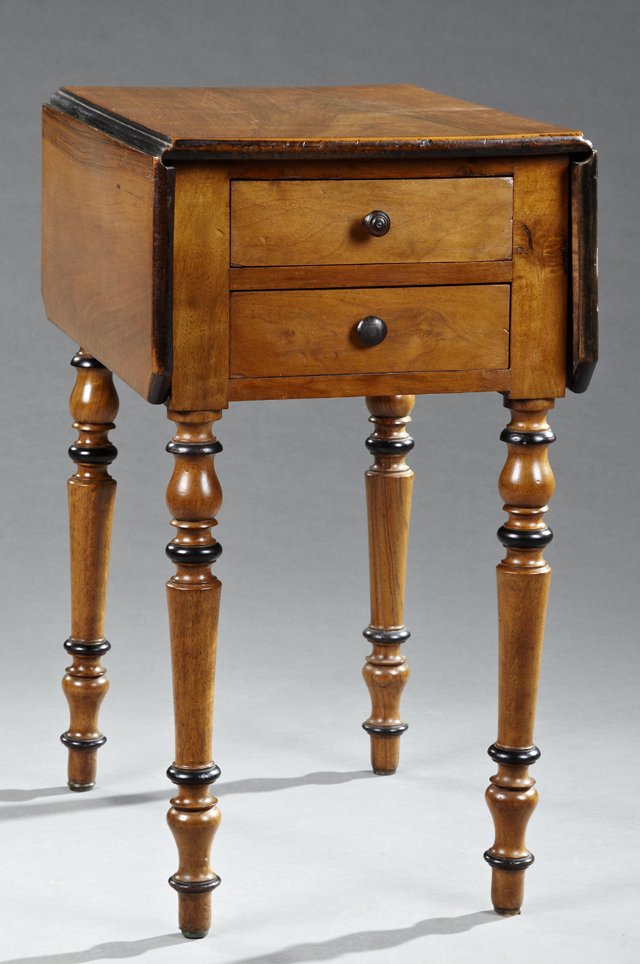 Late French Empire Carved Walnut Drop Leaf Work Table,: Late French Empire Carved Walnut Drop Leaf Work Table, 19th c., the canted corner rectangular top over a wide skirt centered by two drawers, on one end, and a drop front cupboard on the other, on ring