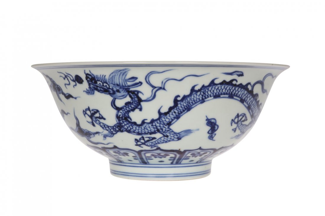 A Chinese blue and white porcelain bowl: A Chinese blue and white porcelain bowl, with slightly flared rim, painted to the exterior with two four-clawed dragons in pursuit of flaming pearls, bears six character Xuande mark. 9.5cm by 21cm