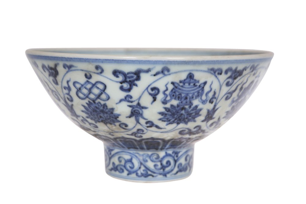 A Chinese blue and white footed bowl: A Chinese blue and white footed bowl, painted in Ming style with continuing scrolls and lotus, bears six character Xuande mark, within a double box, further within double rings, to well of the bowl. 8