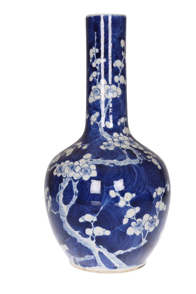 A Chinese blue and white porcelain bottle vase: A Chinese blue and white porcelain bottle vase, painted with prunus blossom against a blue ground, bears four character mark, probably 19th Century. 35cm