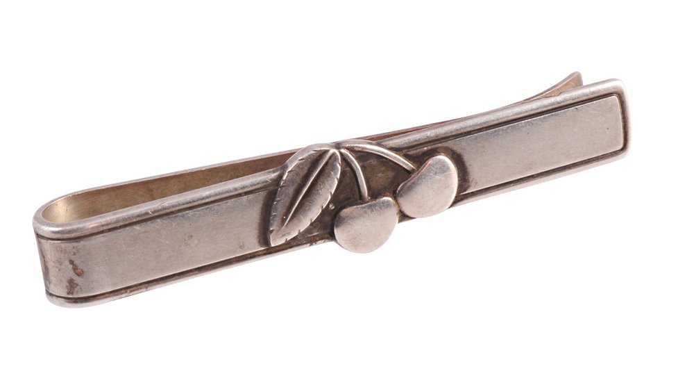 Georg Jensen. A silver tie clip by Georg Jensen: Georg Jensen. A silver tie clip by Georg Jensen, the rectangular bar with moulded edge detailing set to the centre with a pair of cherries, engraved to the reverse PETER HEERING. Stamped 925 S Denmark