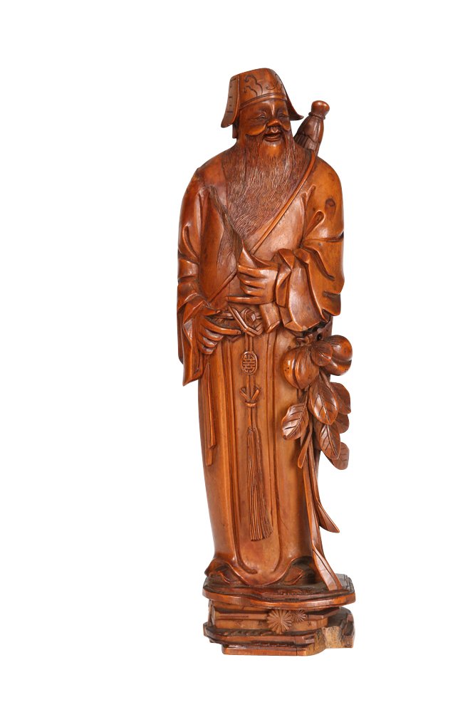 A Chinese carved wooden figure: A Chinese carved wooden figure, the man standing in a long robe and with long beard. 21cm