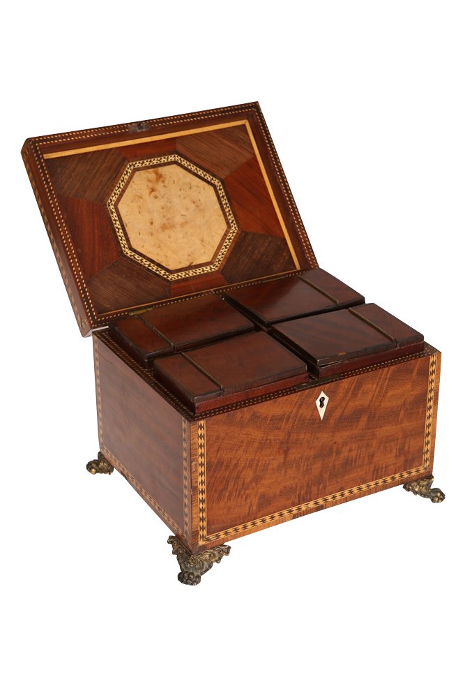 A George III kingwood crossbanded and boxwood inlaid: A George III kingwood crossbanded and boxwood inlaid mahogany tea caddy, the hinged rectangular lid with an assortment of veneers to the underside and centred by a burr panel, the interior with four c