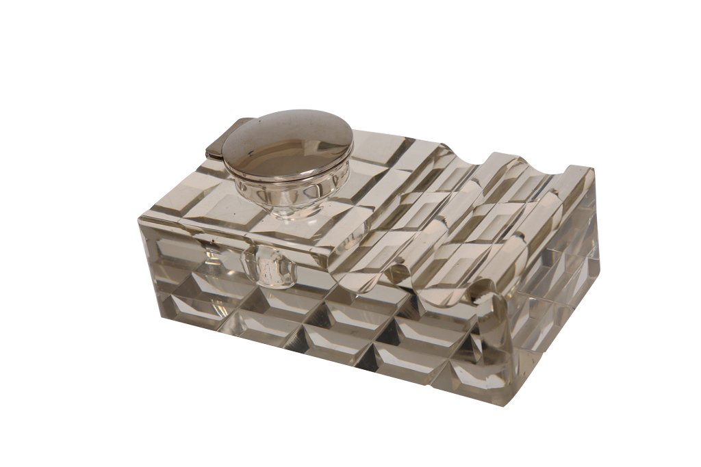 An Edwardian silver and glass inkwell: An Edwardian silver and glass inkwell, Walker & Hall, Sheffield 1903, with twin pen rests and square prism cut base. 14cm by 8.5cm