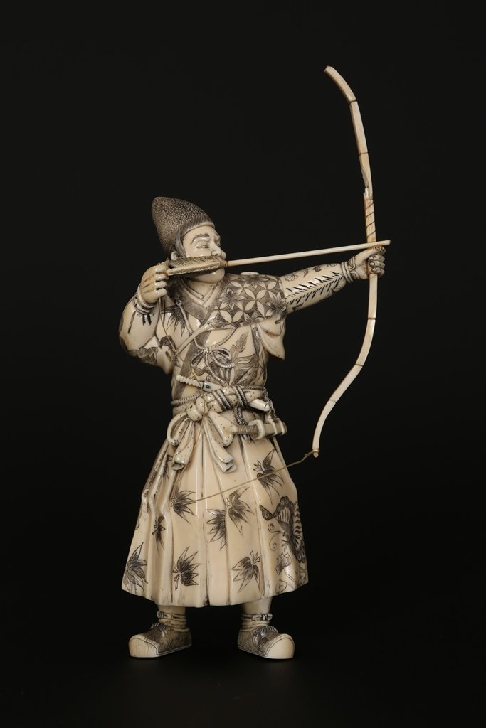 A Japanese ivory Okimono: A Japanese ivory Okimono, Meiji period, modelled as a Samurai archer, signed with two characters, (a/f). 17cm to top of head