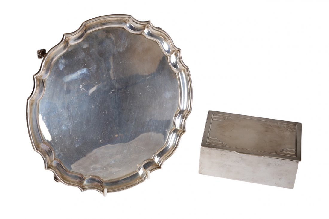 A silver salver, J.B. Chatterley & Sons: A silver salver, J.B. Chatterley & Sons, Birmingham 1973, in Georgian style with moulded rim, raised on three scroll feet, 15.9oz, 25.5cm; together with a silver cigarette box, Richard Comyns, London