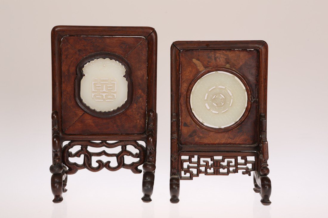 A CHINESE CARVED JADE MEDALLION OF CIRCULAR FORM: A CHINESE CARVED JADE MEDALLION OF CIRCULAR FORM MOUNTED IN A LATE 19TH CENTURY HARDWOOD TABLE SCREEN, 16cm high; together with another larger table screen with shaped rectangular jade medallion with 
