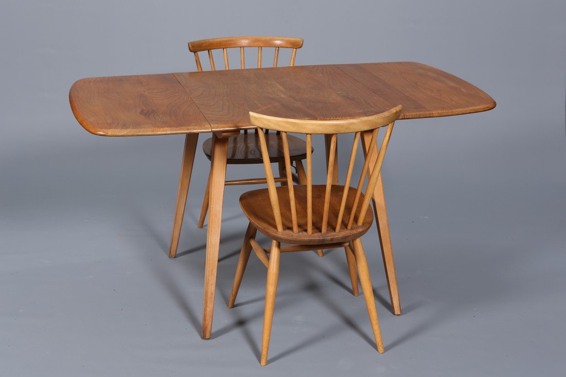 ERCOL A VINTAGE ELM DINING SUITE, comprising sideboard,: ERCOL A VINTAGE ELM DINING SUITE, comprising sideboard, dropleaf table and two chairs, all raised on splayed legs. Table 72cm by 136cm (open) by 76cm