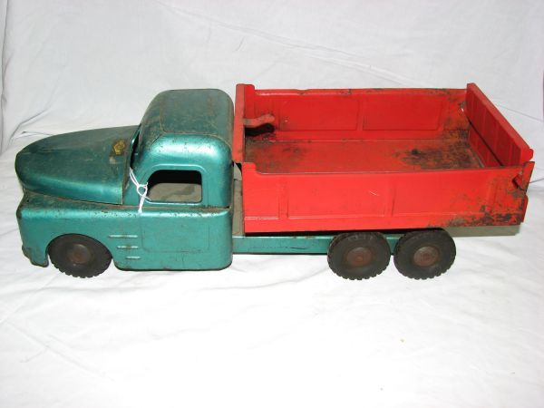 Early Structo Dump Truck: Early Structo Dump Truck. Measures 19 inches long, 6 1/4 inches tall and 6 1/4 inches tall.