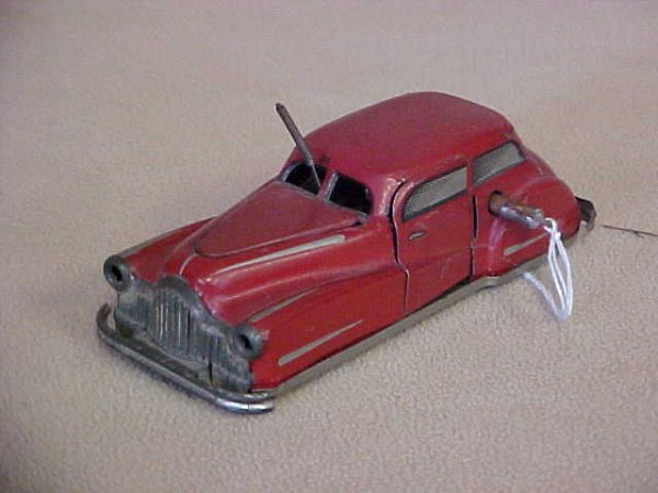 France #2002 Wind up car: France #2002 Wind up car. Paint scratches & wear from age & usage. Measures 5-1/4"long x 1-3/4"tall x 2-1/4"wide.