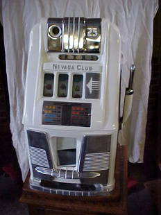 Mills Nevada Club 25 cent slot machine restored.: Vintage Mills Nevada Club 25 cent slot machine. Restored w/custom base. Beautful restoration, oak case. Machine measures 26"tall x 16"wide x 16"deep. Has a custom made oak base w/brass clawfeet,