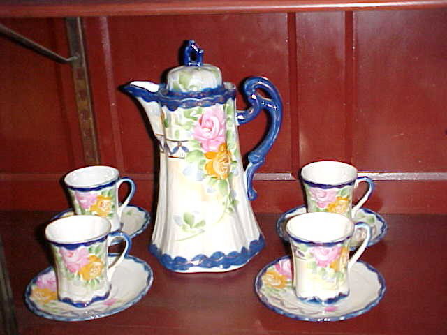 Early Nippon cobalt blue handpainted chocolate set.: Early Nippon cobalt blue handpainted chocolate set. Signed on bottom with green mark. No damage or repairs. Chocolate pot measures 8-1/2"tall x 5-1/2"wide.
