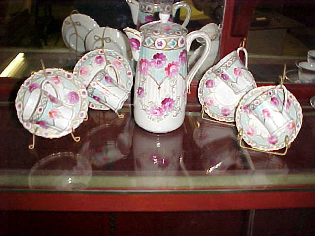 Victoiran chocolate set handpainted pitcher : Victoiran chocolate set handpainted pitcher & cups w/saucers. Possible Nippon but not marked. Pitcher measures 9"tall x 6"deep. No damage or repairs.