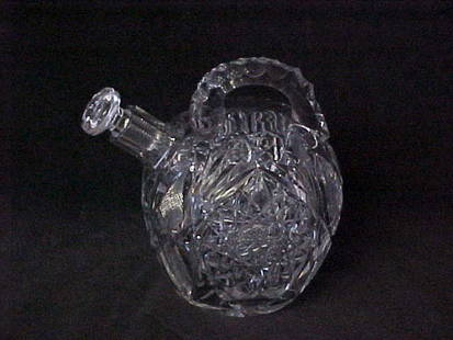 Brilliant cut crystal unusual bottle w/stopper.: Brilliant cut crystal unusual bottle w/stopper. Fantastic styling, unusual crystal bottle w/handle. The stopper has a tiny chip on end of stopper, see photo's. Didn't see any markings. Measuring 7"tal