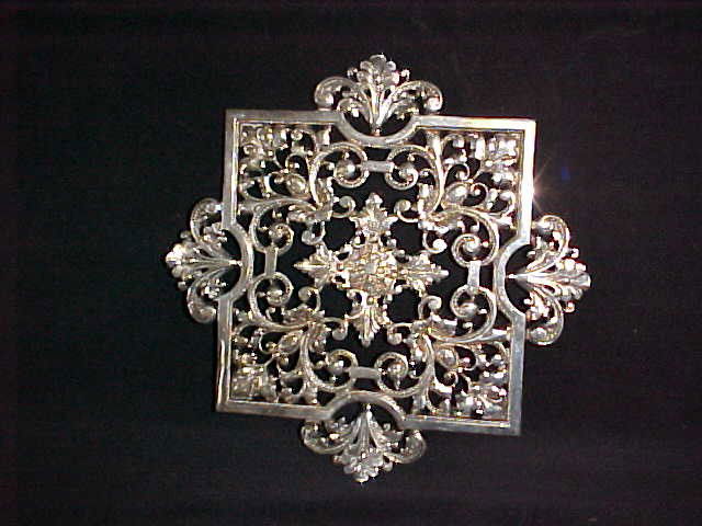 Beautiful quality silver trivet very ornate design: Beautiful quality silver trivet very ornate design. Not signed but outstanding ornate detailed pattern trivet standing on 4 squaty bunn feet. Great quality silver/silverplate? Measures 11" square.