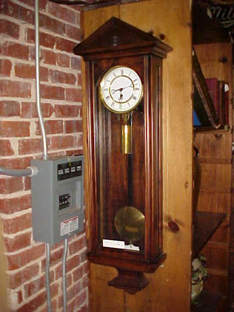 Mahogany case Antique Wall clock w/1 wieght.: Mahogany case Antique Wall clock w/1 wieght. Porcelain face w/sigle weight clock, has correct original pedulum & key. Didn't see any name on clock or on the works. Clock works, minor scratches & wear