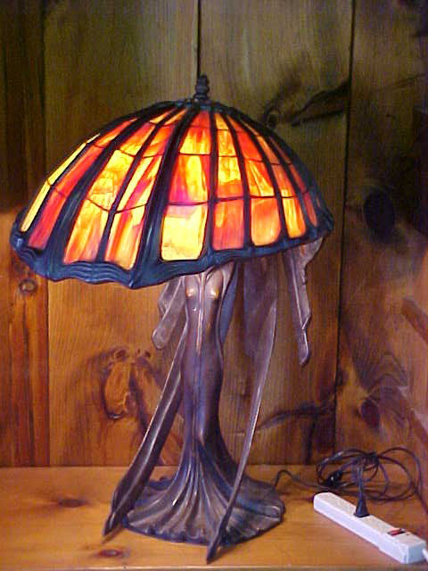 Lg. Tiffany Style Bronze Lamp w/ Bronze Lady Base: Quality Reproduction Lg. Tiffany Style Leaded Glass & Bronze Lamp w/ Bronze Lady Base Measures 19" x 24" x 30 1/2"high. Very heavy weighs around 80lbs.