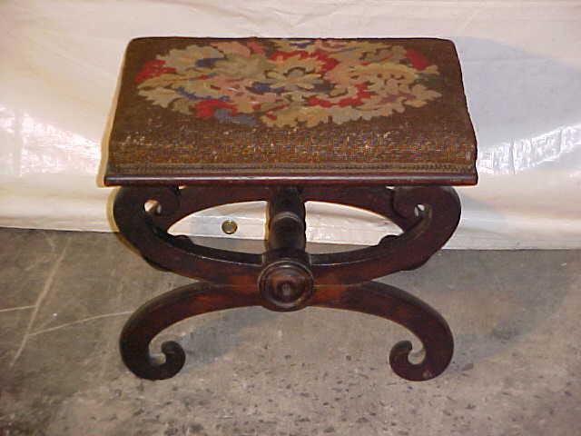 Period Empire needlepoint foot stool.: Period Empire needlepoint foot stool. Flame croch mahogany veneer, original finish w/needlework. Measures 14-1/2"tall x 19"wide x 14-1/2"deep.