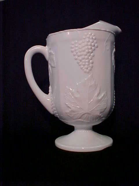 Indiana Glass Co. Milk glass water set pitcher &: Indiana Glass Co. Milk glass water set pitcher & glasses. Harvest pattern. Pitcher 10-1/2"tall x 6"wide & (6) tumblers 5-3/4"tall x 3-1/2"wide.