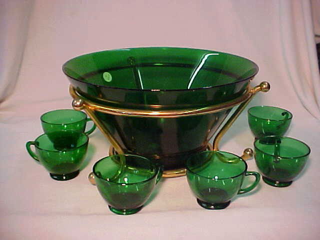 Art Deco Emerald green punch bowl & cups Anchor H: Art Deco Emerald green punch bowl & cups Anchor Hocking glass Co. Bowl measures 7"tall x 12"wide & (6) cups 2"tall x 4"wide.