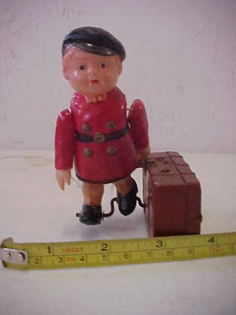 1930's celluloid boy w/tin suitecase windup.: 1930's celluloid boy w/tin suitecase windup. No key. Minor scratches from age & usage.