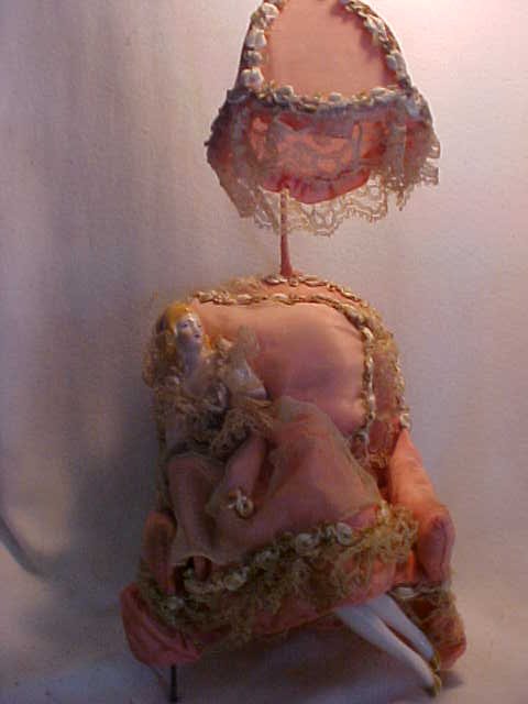 Porcelain lady in chair w/umbrella: Porcelain lady in chair w/umbrella. Measures 12" tall x 6" wide