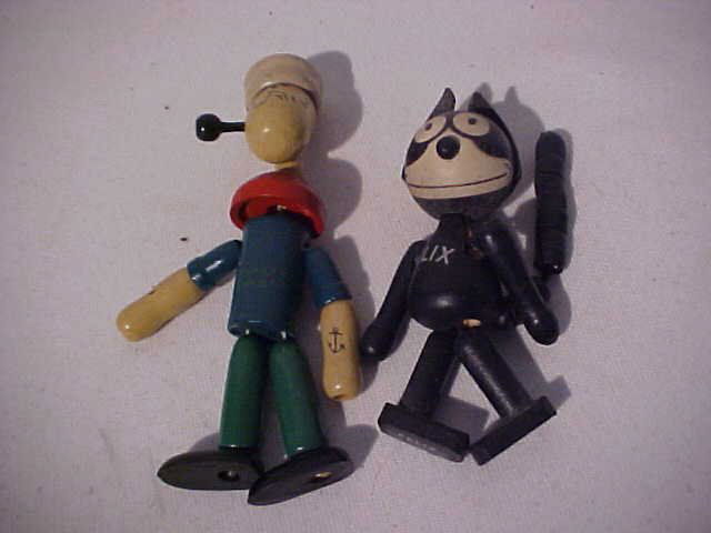 Lot of 2 early wooden toys: Lot of 2 early wooden toys. Felix the cat measures 5"' x 2". Popeye the sailor measures 5 1/2" x 2".