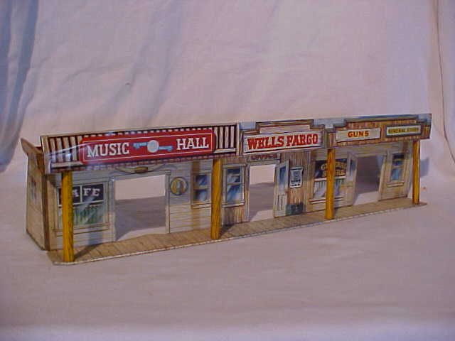 Tin litho store front scene toy: Tin litho store front scene toy. Made by Marx. Measures 5"H x 20"W x 4"D