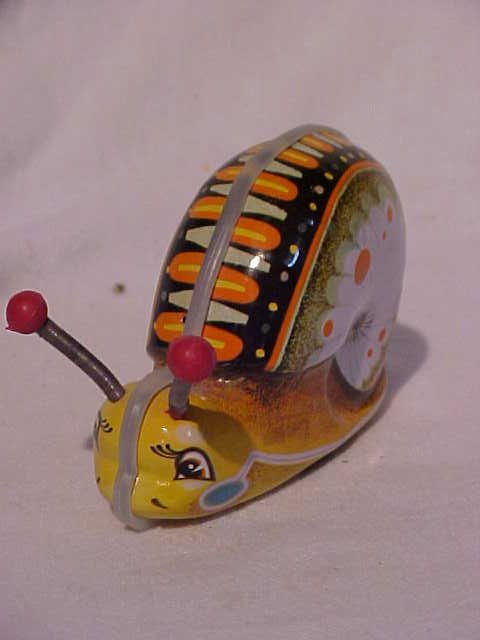 Tin litho snail wind-up toy: Tin litho snail wind-up toy. Measures 3"H x 2"W x 4 1/2"L