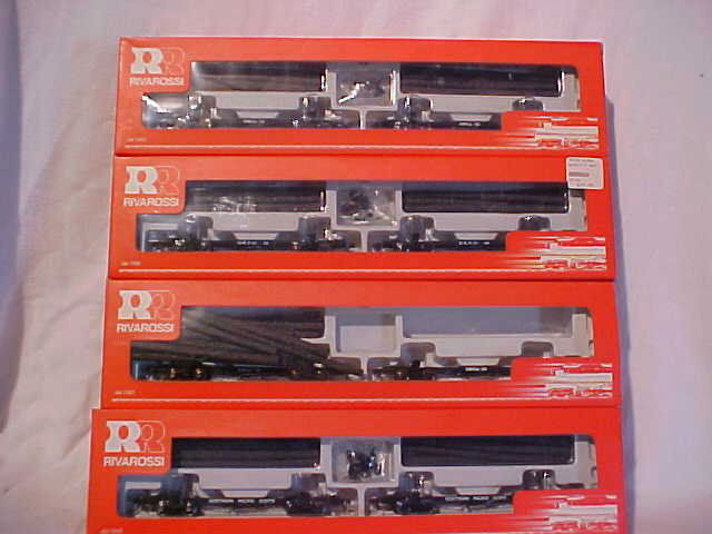 Lot of 4 Rivarossi model train log car sets: Lot of 4 Rivarossi model train log car sets. Consists of: "Northern Pacific", (2) "Ohio Match Co.", and "St. Regis". Still in original boxes. HO scale. Measures 1/2"H x 1 1/2"W x 6"L