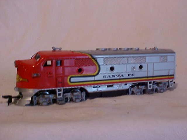 Model Power "Santa Fe" model train engine: Model Power "Santa Fe" model train engine. Still works. HO scale. Measures 2 1/2"H x 1 1/2"W x 7 3/4"L