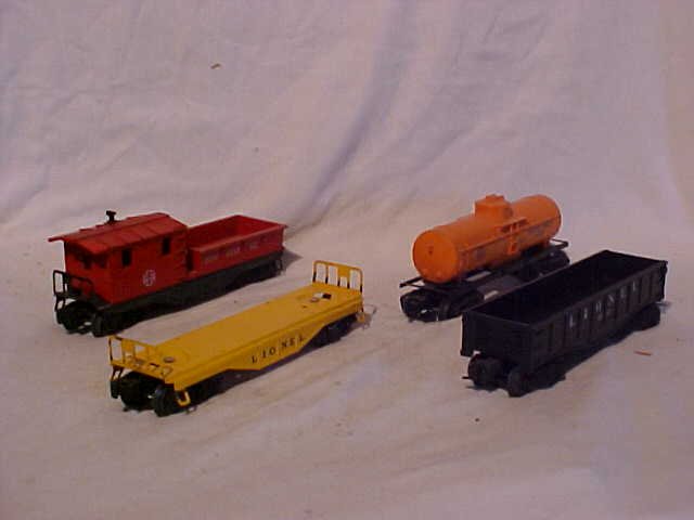 Lot of 4 Lionel Model Train Cars: Lot of 4 Lionel Model Train Cars 0/0-27 Scale Including Santa Fe 6130, Flat Car, Gulf 6025 and 6112 Good Condition Minor Paint Scratches Measures 1 3/4"-3 1/4"h x 2"-2 1/4"w x 8"-8 1/2"L