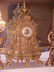 56: Solid brass 3 piece clock set w/candle stands.