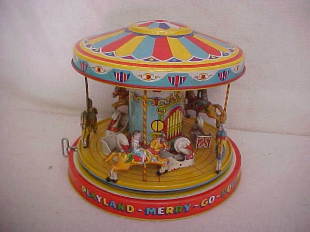 Early tin litho wind up playland merry go round: Early tin litho wind up playland merry go round. Does work. Measures 9 1/2" x 9 3/4"