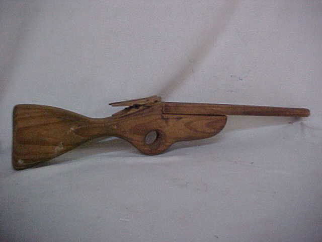 Early wooden double barrel rubberband gun: Early wooden double barrel rubberband gun. Measures 19 1/2"L x 3 1/2"