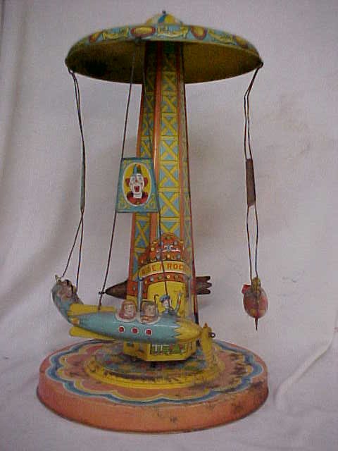 Early tin litho wind up Ride a Rocket: Early tin litho wind up Ride a Rocket. Does work. Measures 18" x 10 1/2"