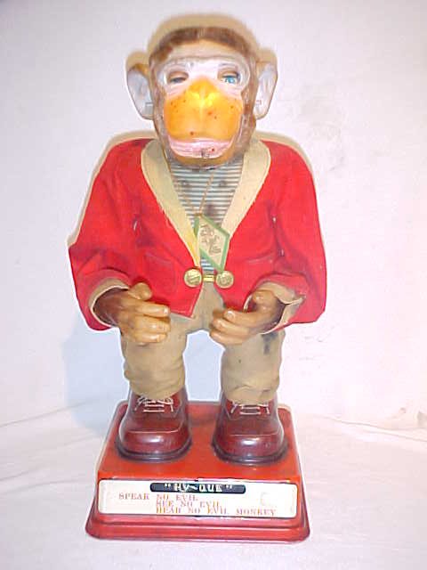 Battery Operated Hy-Que Monkey tin litho. Japan: Battery Operated Hy-Que Monkey tin litho. Battery operated monkey mounted on a tin litho base & shoes. Speak no Evil, See no Evil, Hear no Evil Monkey. Original clothes have scattered staining, tears 