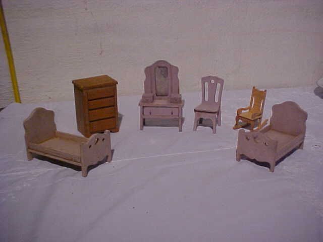 6 pc. Doll house bedroom furniture: 6 pc. Doll house bedroom furniture. 2 beds, chair, rocker, vanity, and chest. Measurements range from 3 1/2" to 5 1/2" tall