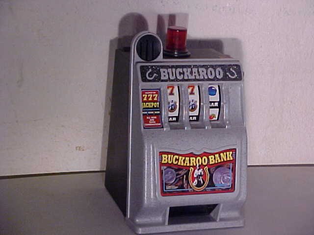 Buckaroo Plastic Slot Machine Bank: Buckaroo Plastic Slot Machine Bank. 9 1/4" tall x 6 1/2" wide x 6" deep.