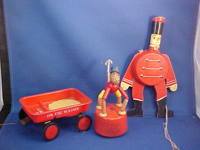 Lot of 3 early small toys: Lot of 3 early small toys. Monkey "funny" no. 154 measures 5"H x 2"W. Small plastic wagon 1966 measures 2-1/8"H x 5"L x 3-1/8"W. Wooden pull string toy (still works) measures 8"H x 4-1/2"W