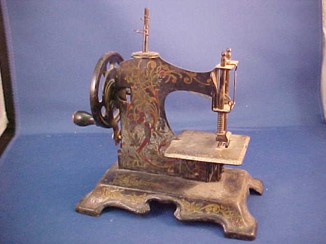 Early child's sewing machine: Early child's sewing machine. Measures 6-1/2"H x 6-1/4"W x 3-1/4"D
