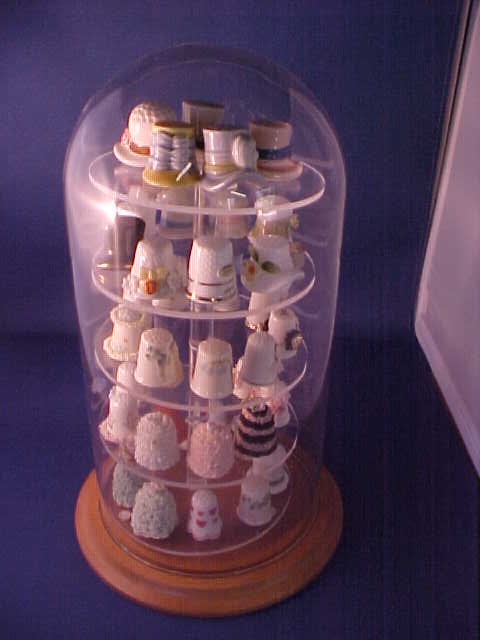 Collection of porcelain thimbles in dome case.: Collection of porcelain thimbles in dome case. Dome case 11"tall.