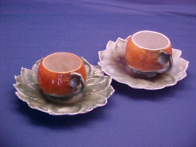 Pair of Royal Bayreuth Orange cups and saucers: Pair of Royal Bayreuth Orange cups and saucers. Measures 4-1/4" wide.