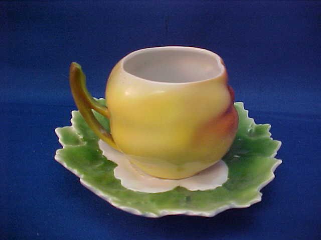 Royal Bayreuth Yellow/Red Apple cup and saucer: Royal Bayreuth Yellow/Red Apple cup and saucer. Measures 4" wide