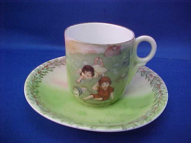Royal Bayreuth 4-1/2\"W Jack and Jill cup and saucer: Royal Bayreuth 4-1/2\"W Jack and Jill cup and saucer