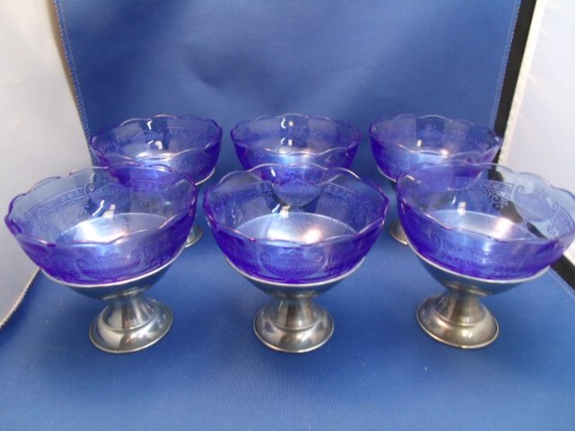 6 Blue Depression Glass Sherbert/Silverplate base: 6 Blue Depression Glass Sherbert/Silverplate base. Each measures 3-1/2" tall x 4" wide.